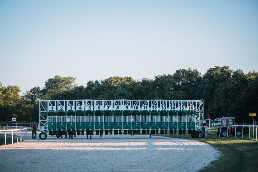 A numbered horse-racing starting gate at a track